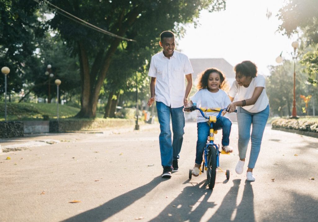 man-standing-beside-his-wife-teaching-their-child-how-to-1128318 (1)